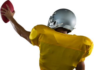 Rear view of American football player with ball