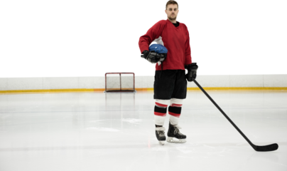 Portrait of ice hockey player holding helmet and stick