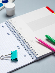 Top view of a flat work desk lies a notebook with blank sheets and stationery. Template for women's blogs in social networks