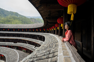 A tourist standing inside a Fujian earthen building