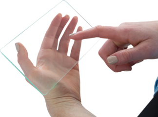 Cropped hand of businesswoman touching glass interface