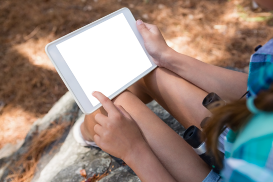 Close-up of girl holding digital tablet in the forest