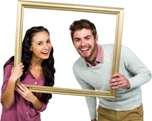 Portrait of happy couple holding picture frame 