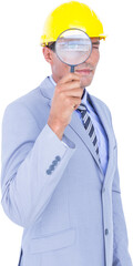 Male architect looking through a magnifying glass