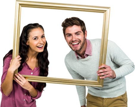 Portrait of happy couple holding picture frame 
