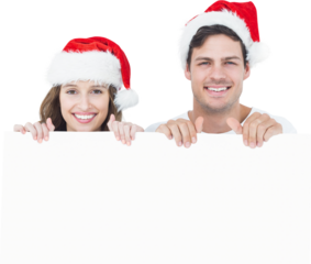 Portrait of cheerful couple with santa hat holding poster