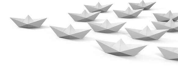 Paper boats arranged on white background