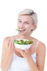 Beautiful blonde woman eating salad