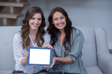 Two beautiful woman holding digital tablet