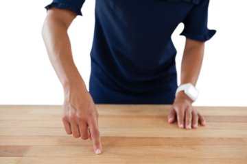 Businesswoman touching invisible screen on wooden table