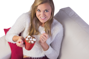 Pretty blonde enjoying hot chocolate on the couch