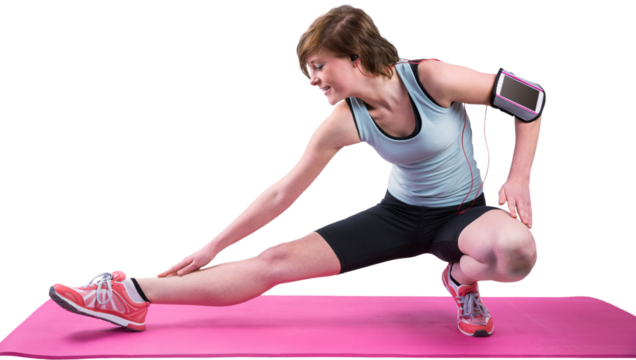 Pretty brunette stretching her leg on exercise mat 
