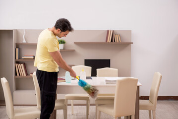 Young man doing housework indoors