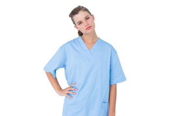  Serious nurse in blue scrubs posing with hand on hip