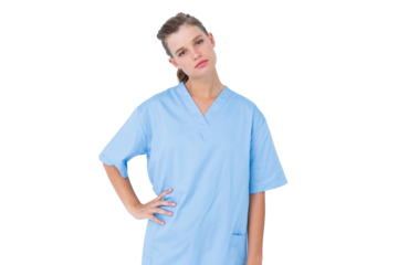  Serious nurse in blue scrubs posing with hand on hip