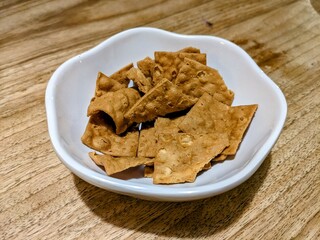 Dried radish cookies in a small white bowl. It is  a traditional sweet and salty snack in Taiwan.