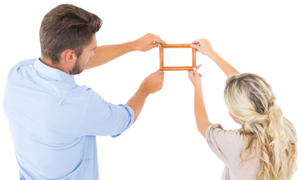 Attractive young couple hanging a frame