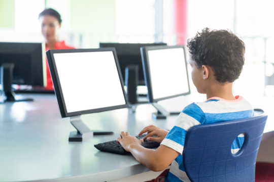 Schoolboy using computer - Powered by Adobe