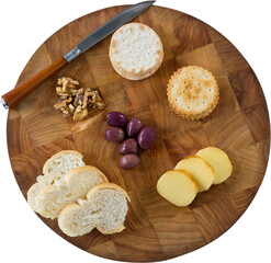 Bread, biscuit, olives, walnut and knife on wooden board
