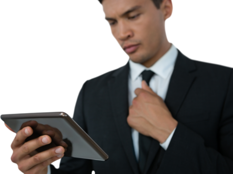 Businessman holding necktie while using tablet computer - Powered by Adobe