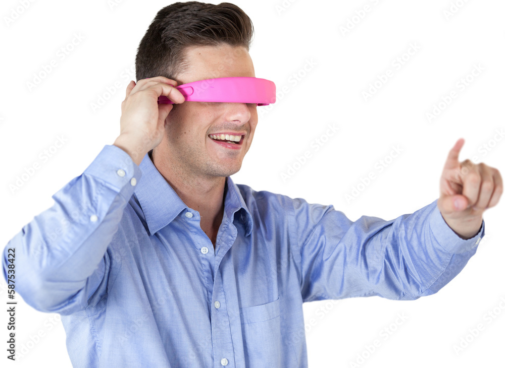 Poster smiling young man gesturing while using virtual reality headset