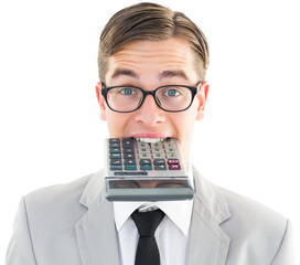 Geeky smiling businessman biting calculator