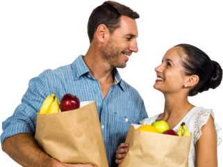 Smiling couple holding grocery bags