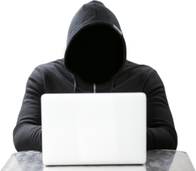 Hacker wearing black hood while using laptop on table
