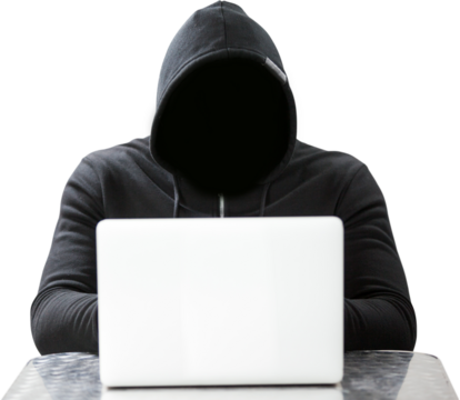 Hacker wearing black hood while using laptop on table