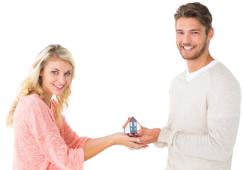 Attractive couple holding miniature house model
