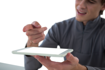 Businessman gesturing over tablet computer