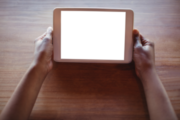 Cropped hands of woman using digital tablet