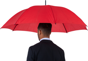 Rear view of businessman carrying red umbrella 