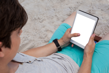 Man using digital tablet on the beach