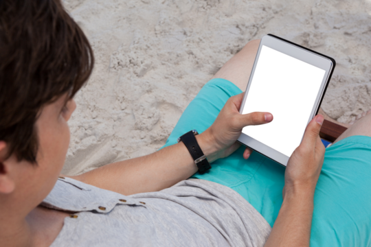 Man using digital tablet on the beach