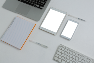 Various electronic gadgets and book on white background