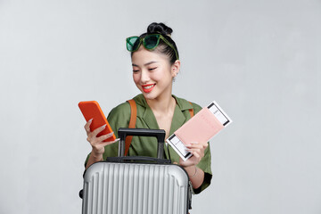 Portrait of nice smiling woman holding passport and flying tickets - 587543647