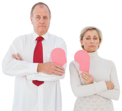 Older couple standing holding broken pink heart