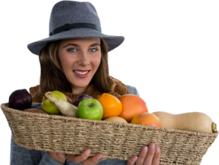 Portrait of young woman carrying fruits and vegetables in basket