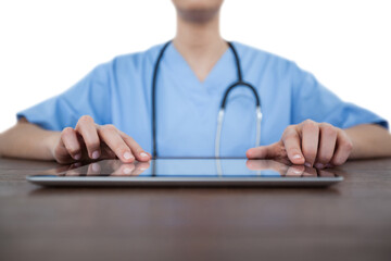Mid-section of female doctor using digital tablet