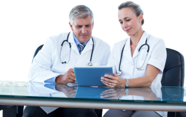 Male and female doctors using tablet computer