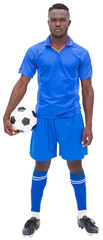 Football player in blue standing with ball 