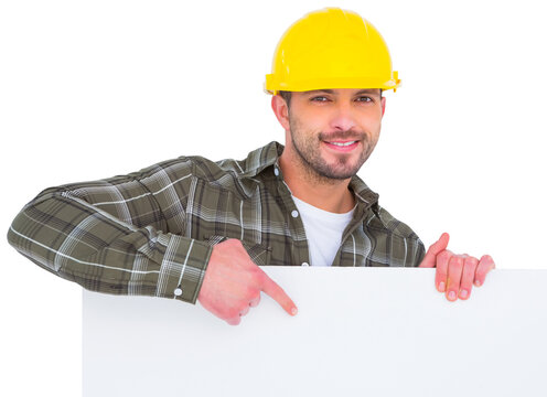 handyman holding and pointing at blank board 