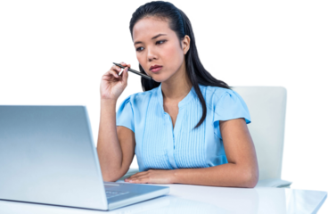 Thoughtful young businesswoman sitting at her desk