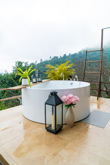 outdoor bath tub with beautiful mountain view background