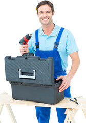 Happy carpenter removing drill machine from tool box