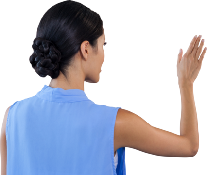 Rear view of businesswoman touching interface - Powered by Adobe