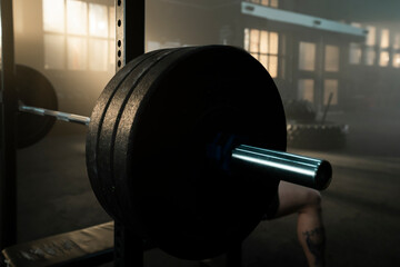 Squat rack. Adjustable barbell stand. Barbell on adjustable rack in gym