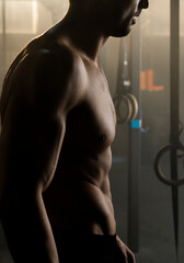 Fototapeta na wymiar Strong athletic man showing naked muscular body. Athlete model posing on camera