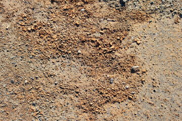 Background texture of gray asphalt. Closeup road surface. Gray road for background or texture. Small fragments of bricks. Brick dust